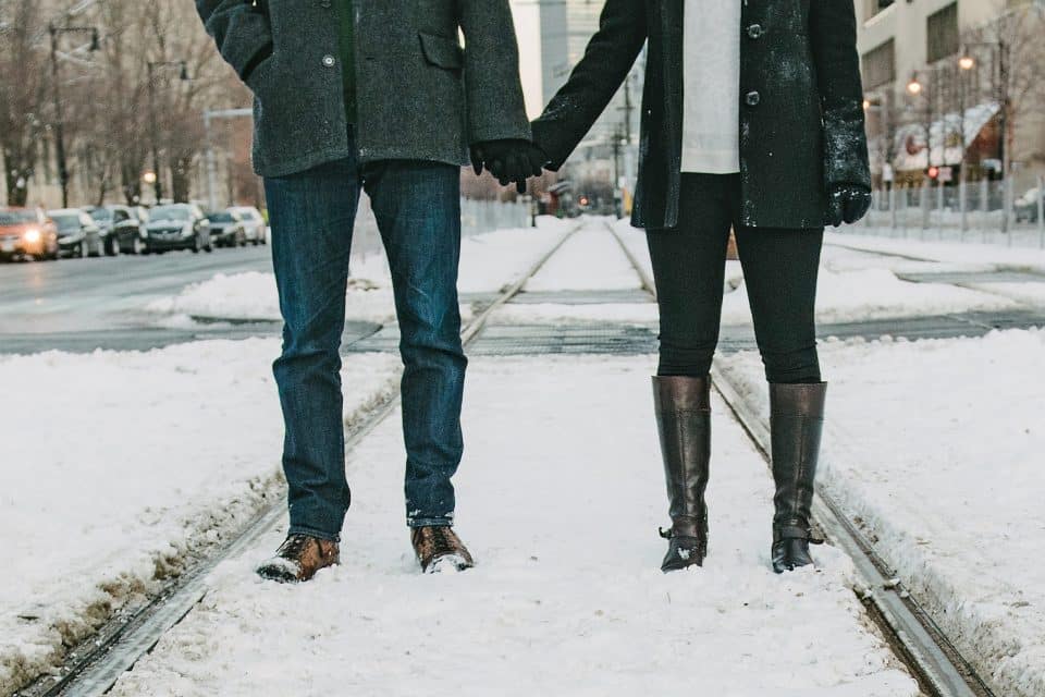 A couple holding hands in the snow