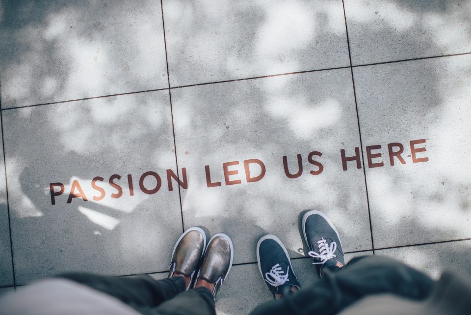A pavement with the words "passion led us here" written on it