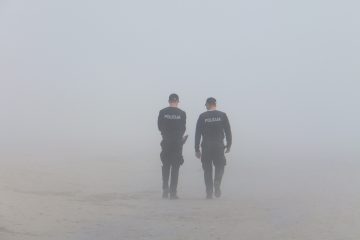 Two policemen walking away from the camera