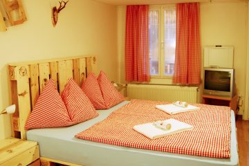 Red and white bedding in hotel toom