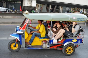 A tuk tuk crowded with people