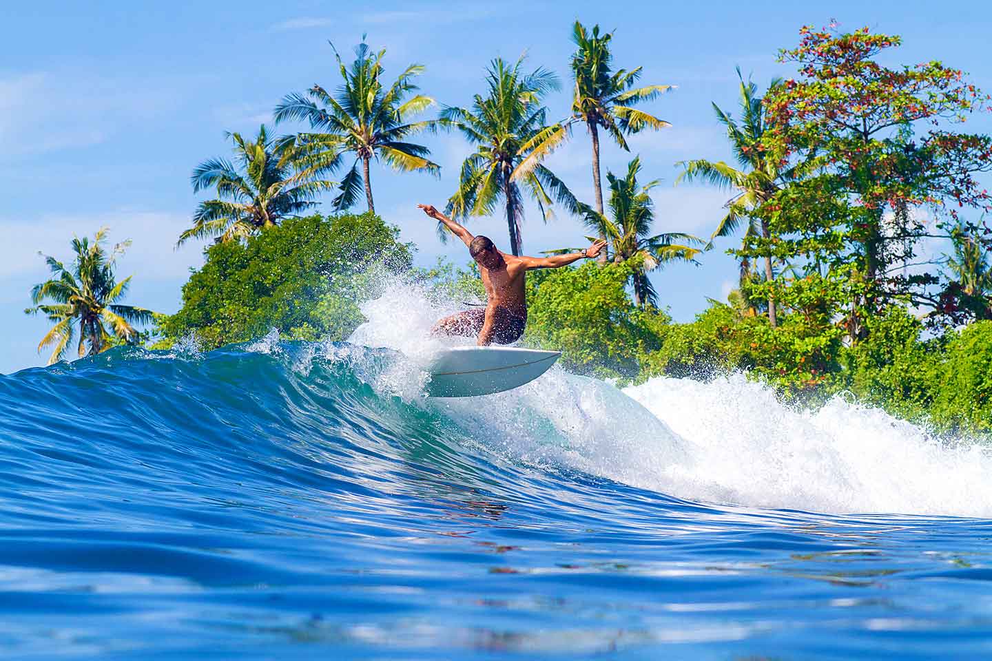 Surfer catching a wave at Uluwatu