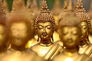 Close up of the faces of golden buddhas
