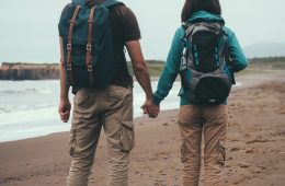 A couple holding hands on a beach
