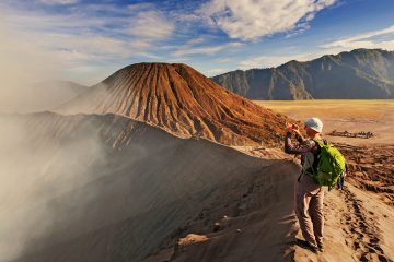 A man taking a photo of Mount Bromo