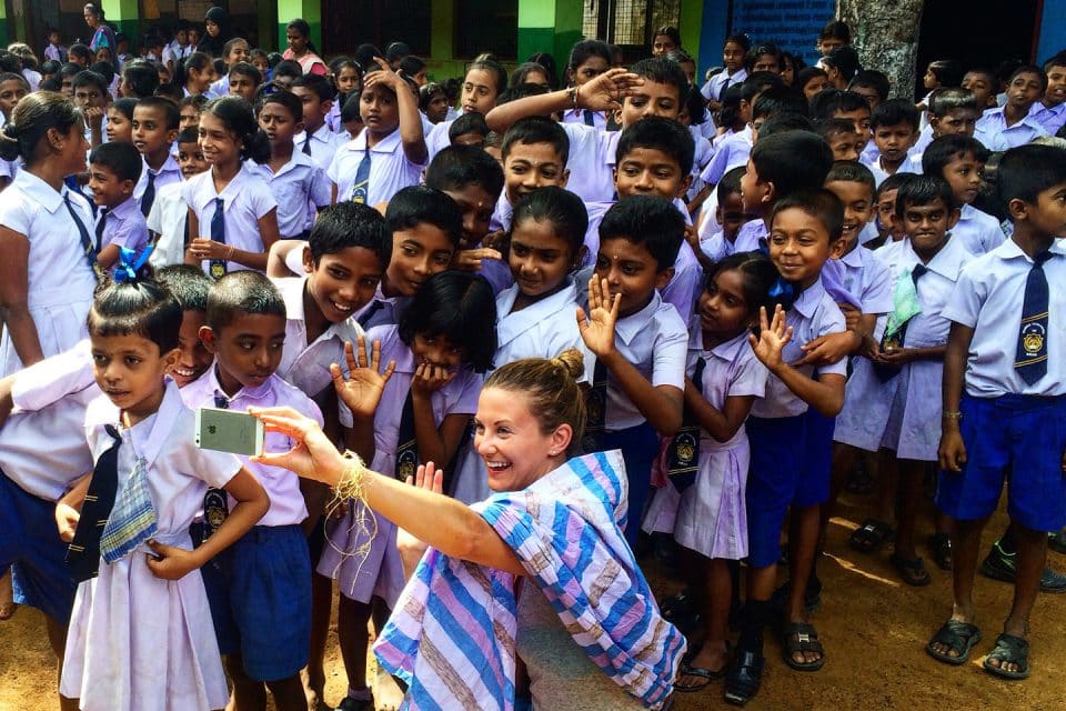 Taking a selfie with a group of kids on the Lanka Challenge