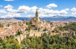 aerial view of Segovia with large church sticking out and blue sky