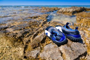 Kayak shoes on sea rock